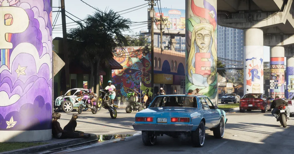 A Vice City street in GTA 6 with murals under a highway overpass, dirt bikes and a lowrider crossing an intersection