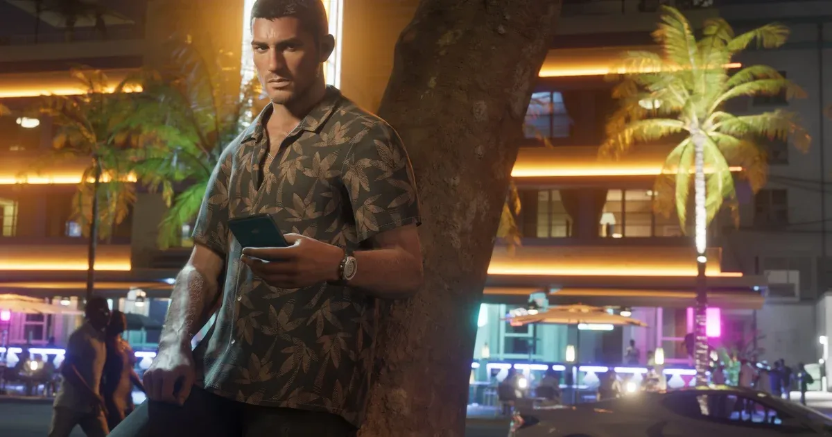 Jason Duval standing beside a palm tree at night checking his phone, with Vice City neon signs lit up behind him